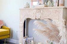 a vintage French mantel with pillar candles, books, a mirror and some more pastel decor is a cool idea for a delicate space
