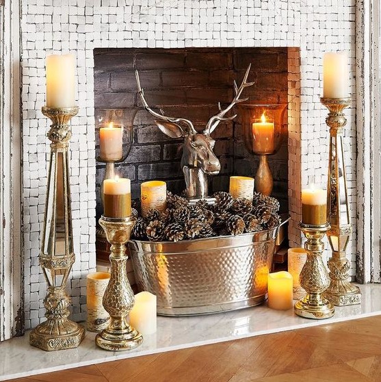 bold rustic styling with candles placed on vintage candle holders, a tub with pinecones and a fake deer head