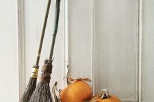 brooms, leaves and pumpkins are cool rustic decor for Halloween and they are easy to compose