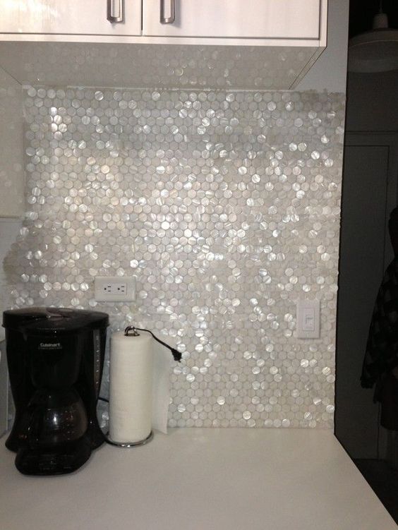 mother of pearl penny tiles will look out of the box and add a touch of shine to the space