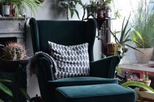 02 a bold boho nook with a dark green wingback chair and a matching footrest, lots of greenery, cacti and artworks