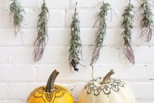 03 a duo of pumpkins decorated with a usual pen in a boho chic way look nice, a greenery garland adds a natural touch