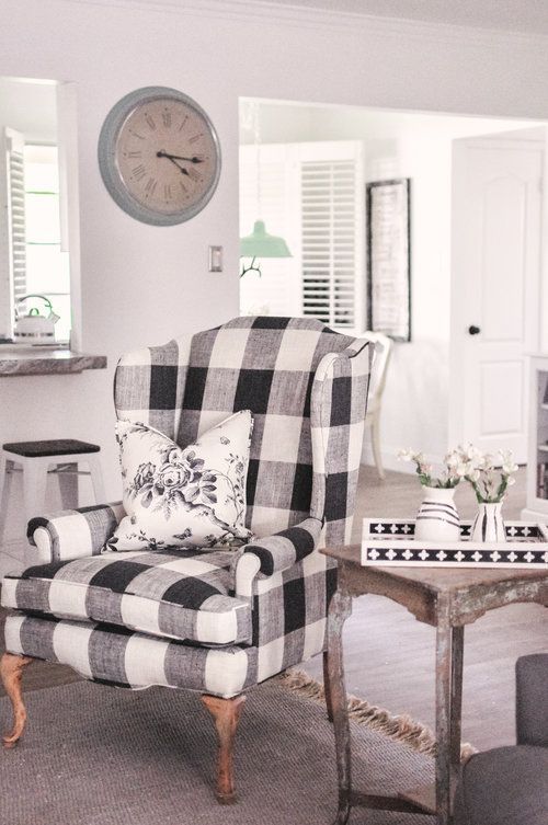 a vintage farmhouse nook with a refined plaid chair, a shabby chic coffee table and printed textiles is very cozy