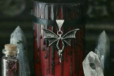 05 a red candle with black dripping, a black ribbon and a bat pendant will be a perfect decoration for a vampire Halloween party
