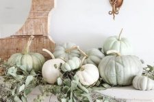 05 simple and very chic mantel decor with greenery and white and green pumpkin is ideal for the fall