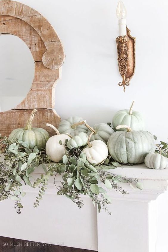 simple and very chic mantel decor with greenery and white and green pumpkin is ideal for the fall