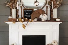 06 a neutral rustic mantel with wooden boards, fabric pumpkins, vine pumpkins, leaves, cotton and wheat and husks