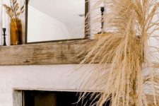 09 lush pampas grass in a vase and dried leaves in a vase add a modern fall feel to the space making it cooler