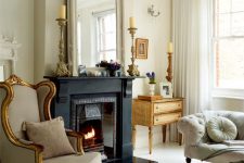 11 a refined Paris living room with a black fireplace, neutral furniture including an exquisite wingback chair, a refined chandelier