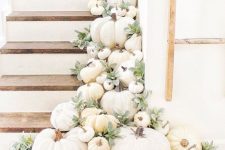 12 neutral gourds, pumpkins and greenery placed right on the steps are an easy way to give a fall feel to your space
