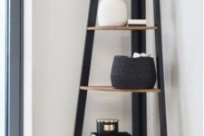 13 a corner shelving unit with rounded shelves and a closed storage space under them is a stylish piece for a modern space