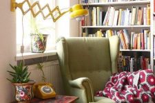 13 a retro cozy reading nook with a large bookcase, a green wingback chair and a yellow wall lamp is very comfortable