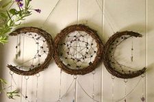 14 a boho-like Halloween decoration of vine showing lunar spheres, weaving, crystals and stars is amazing