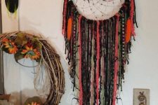 15 a gothic boho dreamcatcher in bright colors and black, with beads and fabric is great for Halloween decor
