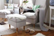 17 dove grey wingback chairs by IKEA with matching footrests, faux fur and pillows form a very cozy nook