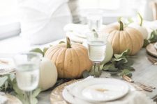 18 a neutral and chic fall tablescape with greenery and natural pumpkins, patterned plates and copper cutlery is easy to recreate