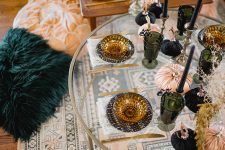 18 boho Halloween party styling with printed plates, black and peachy pumpkins, green glasses and some branches
