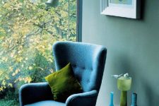 20 a beautiful blue nook with a blue wingback chair by the winfow, a bold artwork and accessories for decorating
