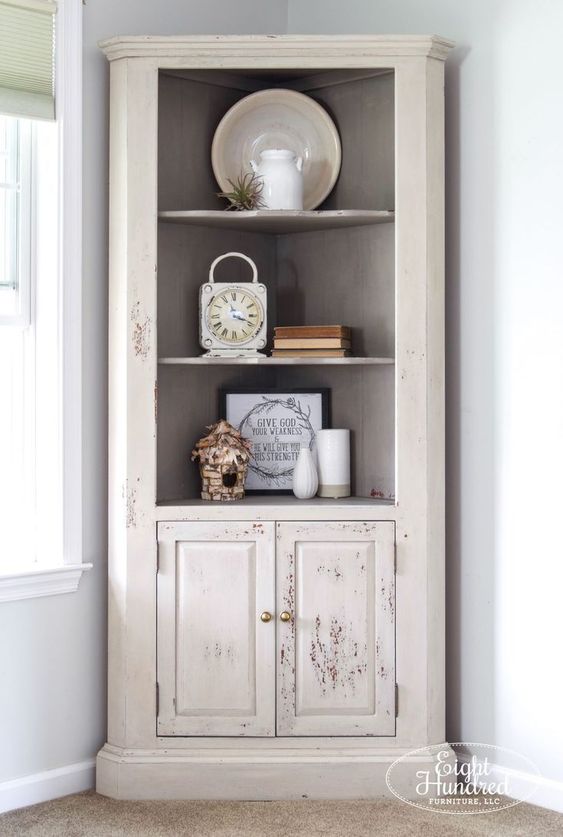 a corner cupboard with open and closed storage units and a slight shabby chic touch is a very refined idea