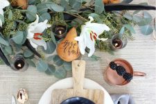 20 a modern fall tablescape with copper cutlery, eucalyptus, antlers, white blooms, pears and copper mugs