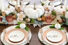 22 a refined neutral Thanksgiving tablescape with neutral linens, white candles, leaves, white and metallic pumpkins and gourds