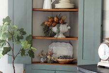 26 a vintage corner cabinet painted green, with rustic shelves is a stylish refined piece to store your things