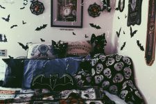 a Gothic Halloween bedroom decorated with paper bats, garlands and signs, with scary bedding and plushies plus lights
