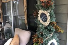 a Thanksgiving tree with faux leaves and chalkboard signs in vintage frames is a stylish piece for indoors or outdoors
