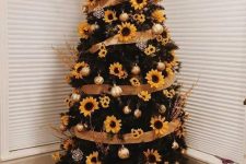a Thanksgiving tree with ribbons, sunflowers, shiny metallic ornaments and branches is a fun rustic idea