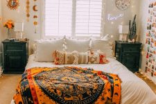 a bright Halloween bedroom with a tarot blanket, cool wall hanging and an eye light over the window