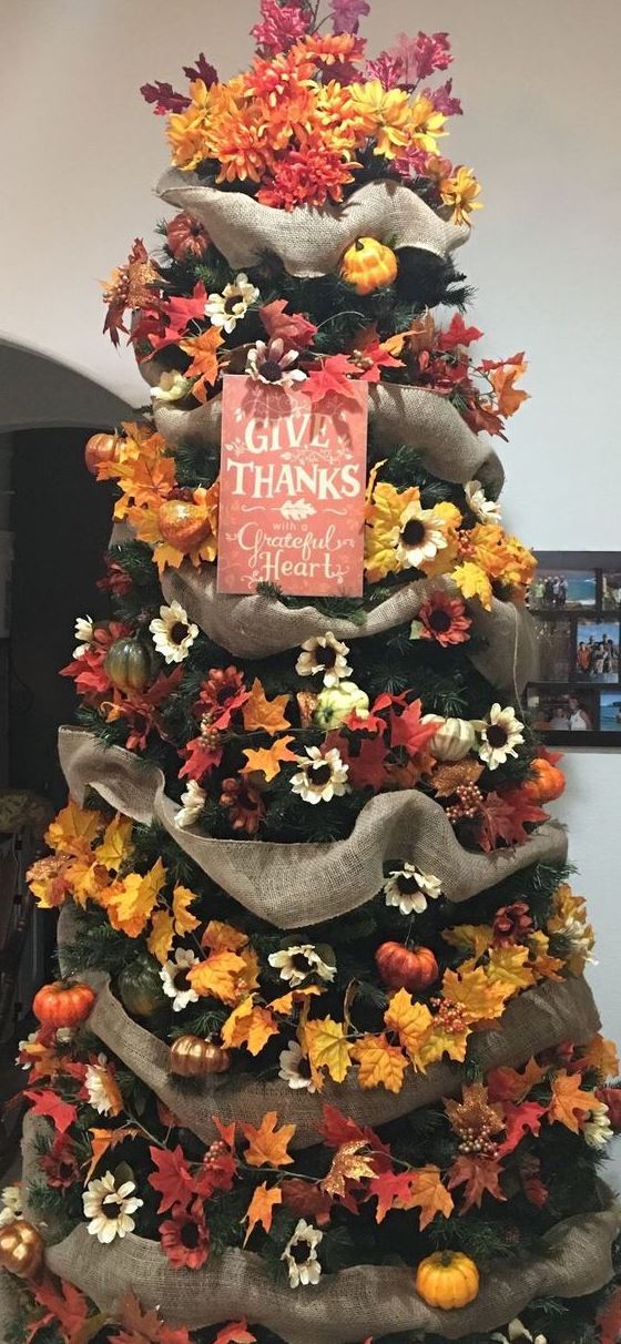 a bright Thanksgiving tree with burlap ribbons, faux blooms, leaves, pumpkins and a sign is a very cool idea
