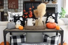 a farmhouse Halloween console with wheat, pumpkins, ghost pillows and dried blooms is ultimate and fun