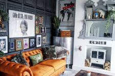 a quirky living room with an orange Chesterfield sofa, a hearth and firewood, a bold gallery wall and mirrors