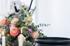 a refined floral Halloween centerpiece with peachy and pink blooms, dried blooms and grasses and much eucalyptus