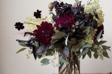 a simple dark floral arrangement of deep purple and white blooms, eucalyptus and dark foliage for Halloween