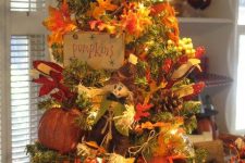 a vintage-inspired fall tree with lights, faux leaves, paper pumpkins, pinecones, berries and plaid decor