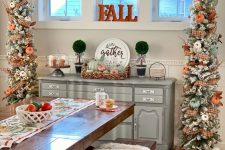 chic snowy Thanksgiving trees with plaid ribbons, white and orange pumpkins, leaves, branches and lights