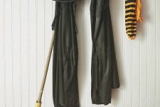 minimalist Halloween styling with black robes, a large hat, pumpkins, leaves and a broom is easy to recreate