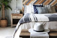 02 a bright wooden headboard done with a pattern and muted colors to add a relaxed boho feel to the bedroom