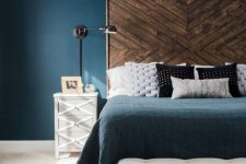 03 a large dark stained wooden headbard with a chevron pattern gives a texture to the bedroom