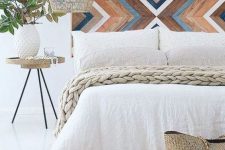 04 a painted wooden headboard with a chevron pattern, a wicker lampshade and a jute rug for a boho meets rustic feel