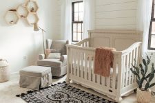 07 a boho meets vintage nursery with a wicker lampshade, hex shelves, a boho rug, grey furniture is very stylish and bold