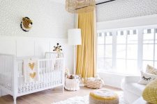 08 a bright nursery in white and yellow, with a fluffy rug, a colorful ottoman and baskets for storage