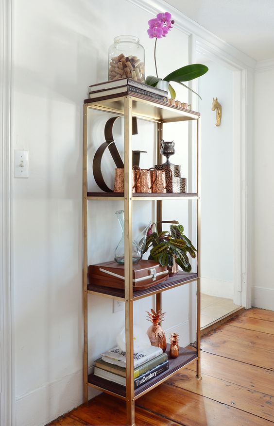 an IKEA Hyllis shelf hacked with gold paint and dark stained shelves brings a touch of rustic glam