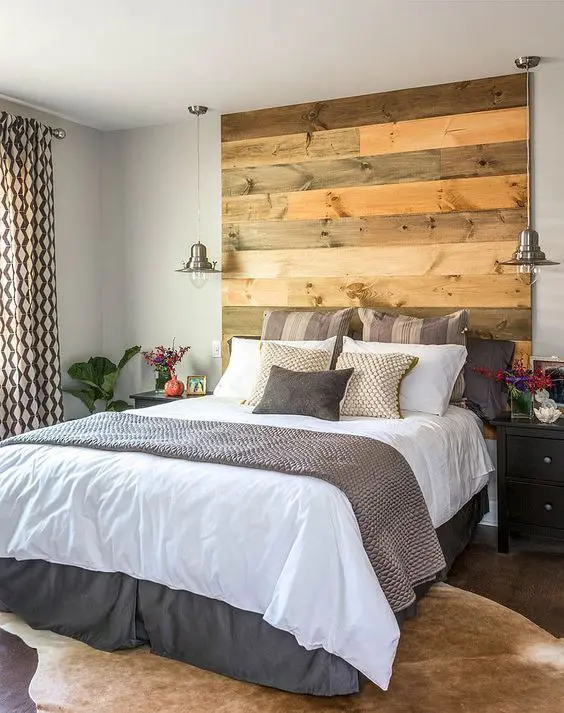 a reclaimed wood headboard coming up to the ceiling makes a statement and adds texture