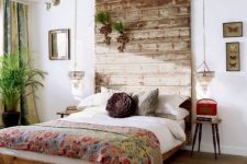 13 a weathered wood headboard that is extended to the ceiling to have a bigger impact