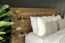 16 a modern to boho bedroom with a reclaimed wooden headboard, brass sconces and a statement plant