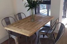 21 a small pallet dining table on hairpin legs and black metal chairs for a rustic industrial space