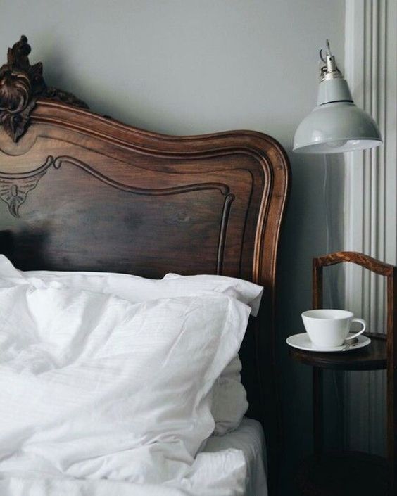 an elegant rich stained carved wooden headboard with chic decor brings a touch of color and elegance to the space