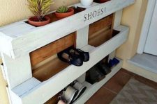 25 an easy pallet shoe rack with stained parts features shoe storage and storage for pots with succulents